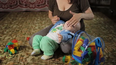 Beautiful kid does not listen to my mother at home. He was less than a year, and Stock Footage 64557345