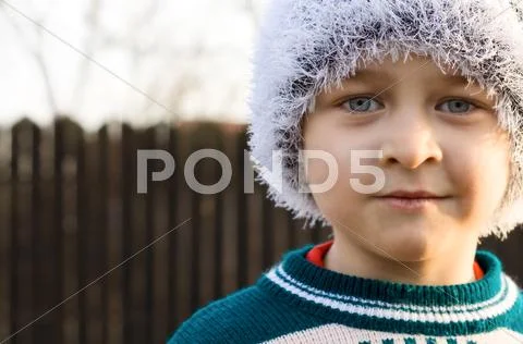 Beautiful kid wearing winter white cap Stock Photos