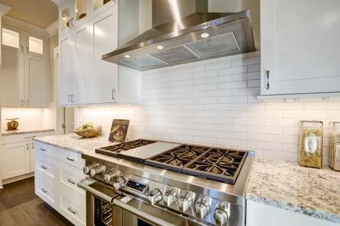 Beautiful kitchen features a nook filled with stainless steel stove Stock Photos