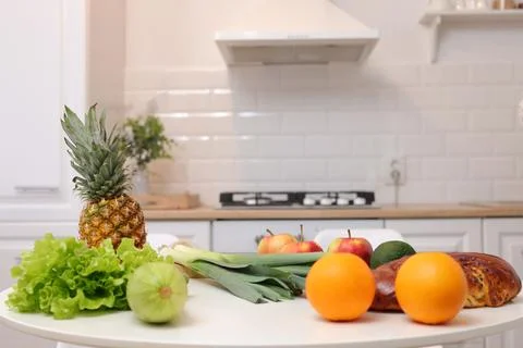 Beautiful kitchen interior design features white table adorned with group of  Stock Photos