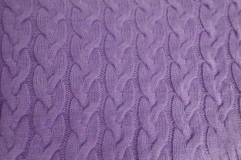 Beautiful knitted braid pattern of light lilac wool yarn, knitted texture, .. Stock Photos