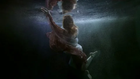 Beautiful lady is floating gracefully under water surface of swimming pool 스톡 동영상 167279259