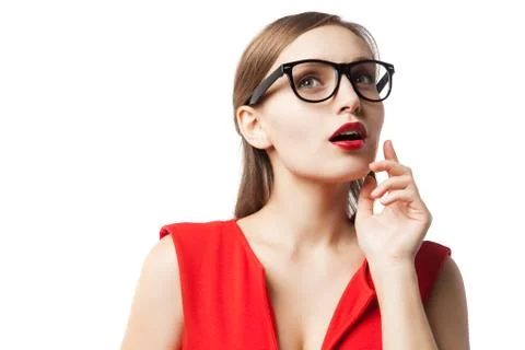 Beautiful lady in glasses thinking while looking up Foto stock
