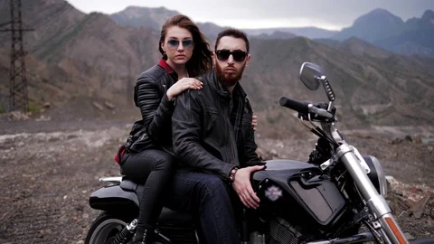 Beautiful lady in jacket sits behind handsome bearded man Stock Footage 111620518