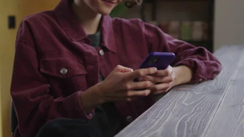 A beautiful lady is looking at something on the phone and smiling Stock Footage 170466262
