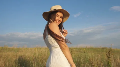 Beautiful lady model posing in an open field at golden hour - outdoors shoot Stock Footage 94390729