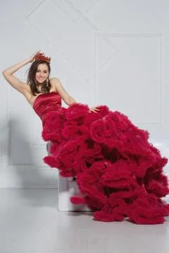 Beautiful lady posing in a studio posing on a sofa. Stock Photos