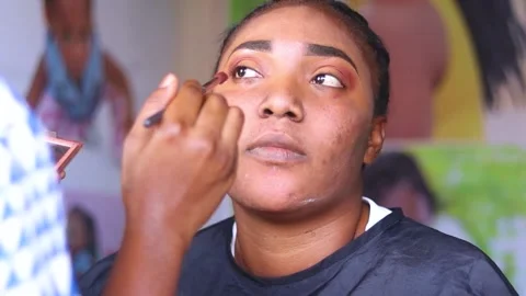 Beautiful lady with red lipstick having makeup treatment. applying eye make-up o Stock Footage 204946341