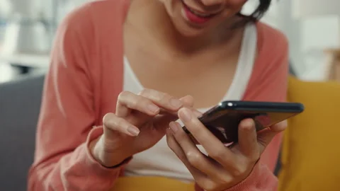 Beautiful lady using smartphone chat with couple sitting on sofa in living room. Stock Footage 147208431