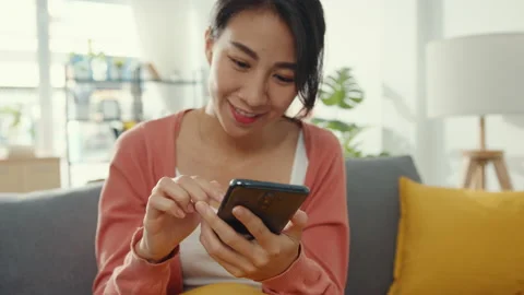 Beautiful lady using smartphone chat with couple sitting on sofa in living room. Stock Footage 149924189