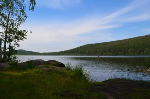 Beautiful lake and the reflection of the clouds Stock Photos
