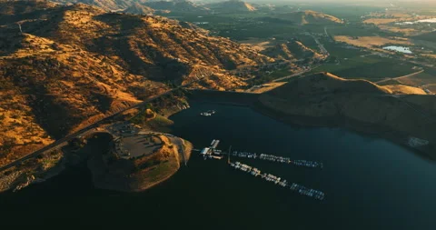 Beautiful lake with dock for yachts and boats surrounded by mountains Stock Footage