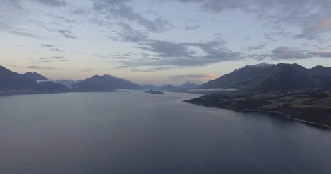Beautiful lake with mountain ranges in background at dusk Stock Footage 119159082