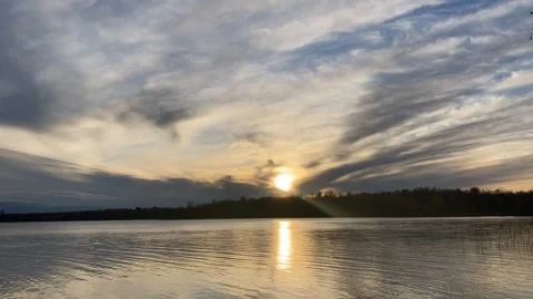 Beautiful lake sunset sequence mirrored in water, goes to colorful red &amp; orange Video stock 264776319