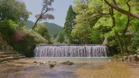 Beautiful landscape of an artificial waterfall and clear stream Vídeos de archivo 332866152