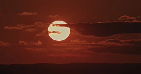 Beautiful landscape of a big sun with clouds of the setting sun over the horizon Stock Footage 278908306