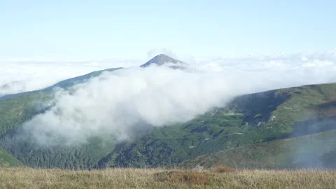 Beautiful landscape cloud covered mountain peak. Rapid change weather Stock Footage 218441584