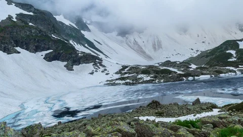 The beautiful landscape with clouds and ice lake in mountain of Caucasus. Stock Footage 115276470