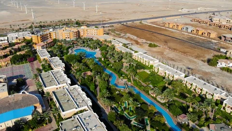 Beautiful landscape in Egypt over palm trees and swimming pool. Drone flight Stock Footage 129233386