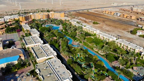 Beautiful landscape in Egypt over palm trees and swimming pool. Drone flight Stock Footage 129233955