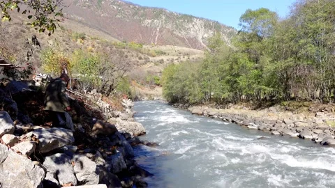 Beautiful landscape with a fast mountain river flowing between rocky stones. Stock Footage 164269351