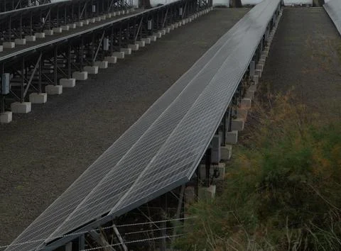 A beautiful landscape featuring rows of solar panels that are effectively har Stock Photos