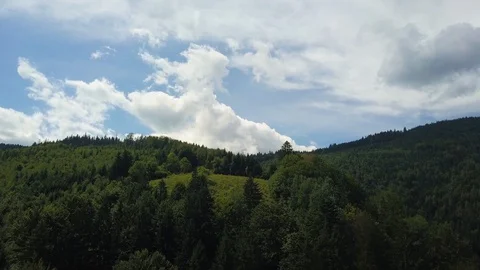 Beautiful landscape, flying over the forest mountains on a background of clouds Stock Footage 129260878