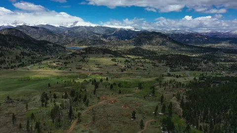 The beautiful landscape of green fields and majestic mountains in CO Stock Footage 247364219