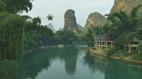 Beautiful landscape with green river floating in a karst landscape in China Stock Footage 68893637