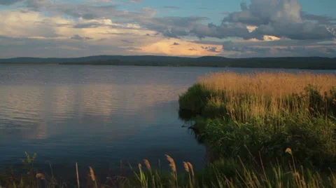 Beautiful landscape . The lake reflected the clouds . The setting sun Stock Footage 68391738