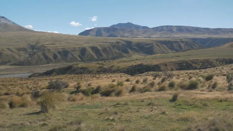 Beautiful landscape of meadows surrounded by mountains, in New Zealand Stock Footage 216884313