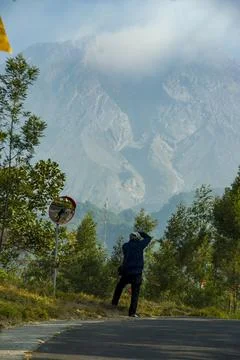 Beautiful landscape of Mount Merapi hills with an asphalt pathway. Stock Photos