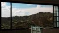 Beautiful landscape out of wide window of an abandoned hotel HD Footage
