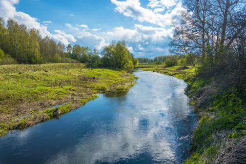 Beautiful landscape with reflection of white clouds in the blue water. Stock Photos