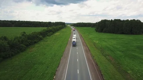 Beautiful landscape with a ride on the highway the trucks and a few cars at Stock Footage