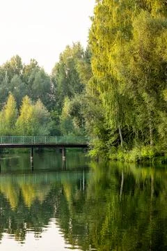 Beautiful landscape on the river with a bridge with reflection during sunset. Stock Photos
