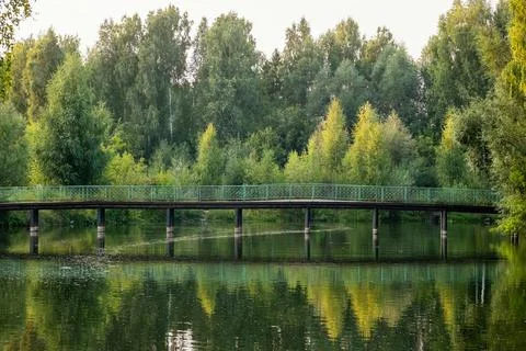 Beautiful landscape on the river with a bridge with reflection during sunset. Stock Photos