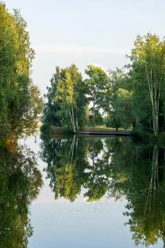 Beautiful landscape on the river with reflection during sunset. Stock Photos