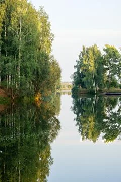 Beautiful landscape on the river with reflection during sunset. Stock Photos