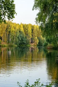 Beautiful landscape on the river with reflection during sunset. Stock Photos