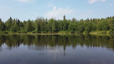 Beautiful landscape on the river in summer. Reflection of trees in the water. Stock Footage 156948162