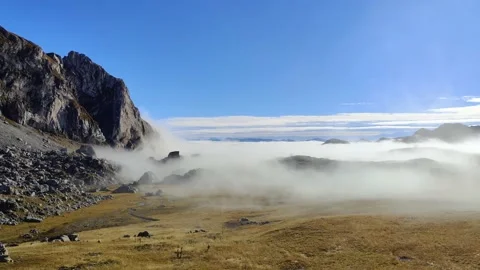 Beautiful landscape scene on the mountain in clouds and fog Stock Footage 230177764