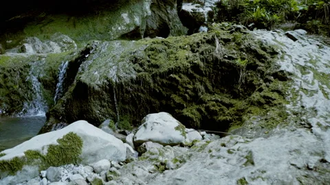 Beautiful landscape, a small stream flows down the green-covered rocks Stock-Footage 131063819