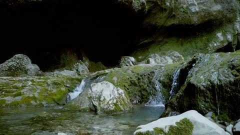 Beautiful landscape, a small stream flows down the green-covered rocks Video stock 131063994