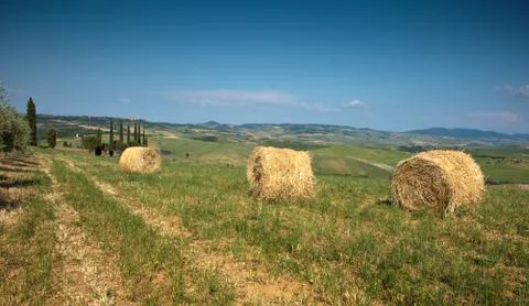 Beautiful landscape with twisted haystack in a field  in Toscana, Italy Stock Photos