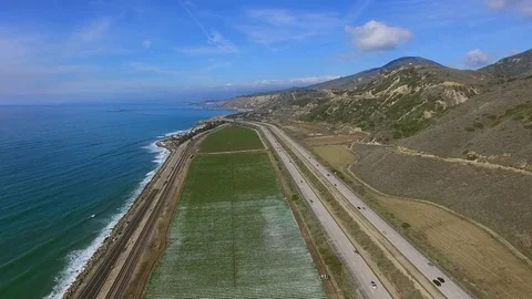 Beautiful landscape view of corn field and highway with cars and coast of the Stock Footage 80962733