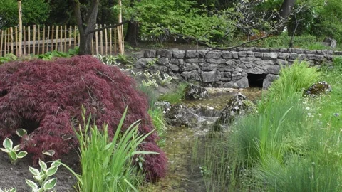Beautiful landscape with waterfall falling from stone wall in japanese styl.. Stock Footage 242437939