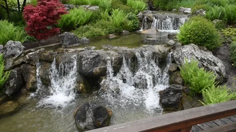 Beautiful landscape with waterfall falling from stone wall in japanese styl.. Stock Footage 242438233