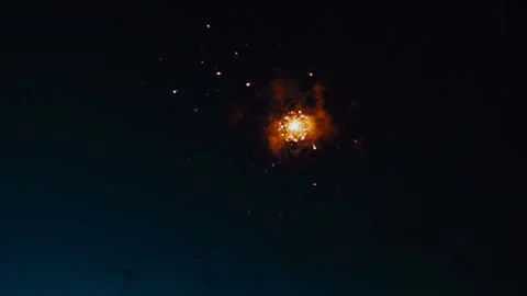 Beautiful large and small orange fireworks explode against the background of the Video stock 234083046