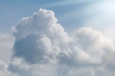 Beautiful large fluffy clouds in the sunny sky Stock Photos